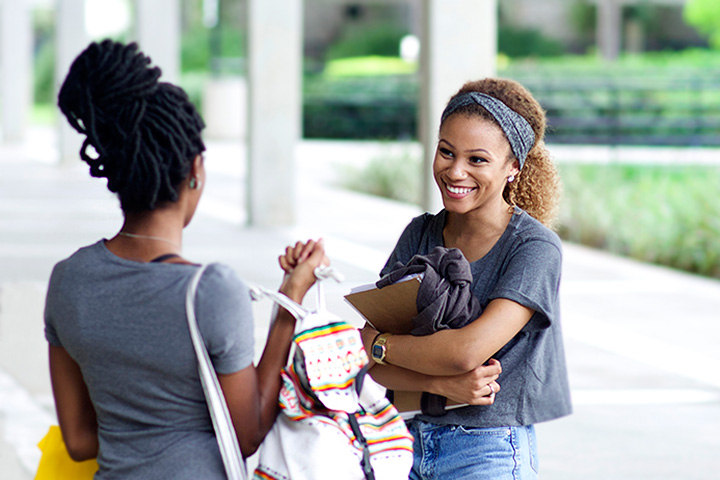 Two girls having a conversation in the hallway