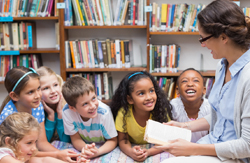 Teacher with kindergarten students sitting around her