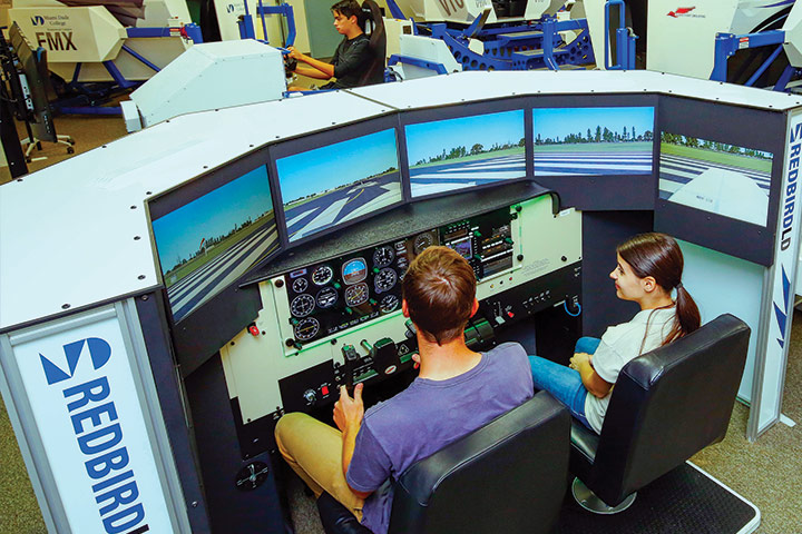 Two students in a flight simulator