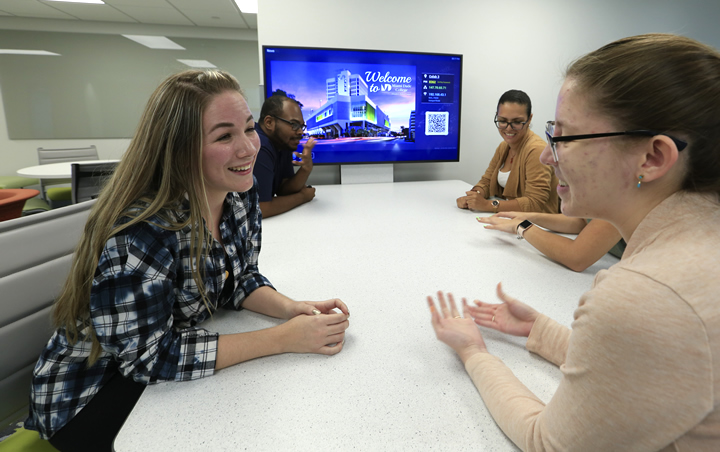 Students at a conference table