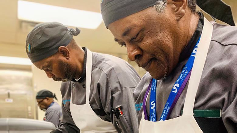 Closeup of two men preparing food