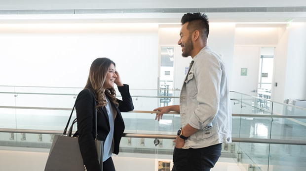 Two students meet up in a hallway