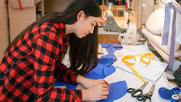 A young woman works on a pattern