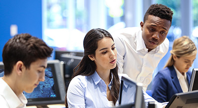 Two tech students working together on their computers