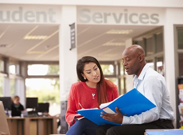 Male student receives guidance from a staff member at Student Services