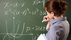 Teacher working in front of a chalk board